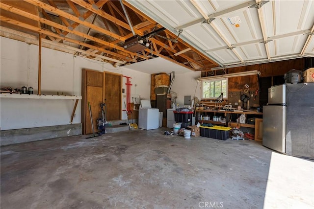 26865 Pine Canyon Rd, Lake Hughes, CA 93532 - garage with freestanding refrigerator, a workshop area, washer / dryer, and a garage door opener