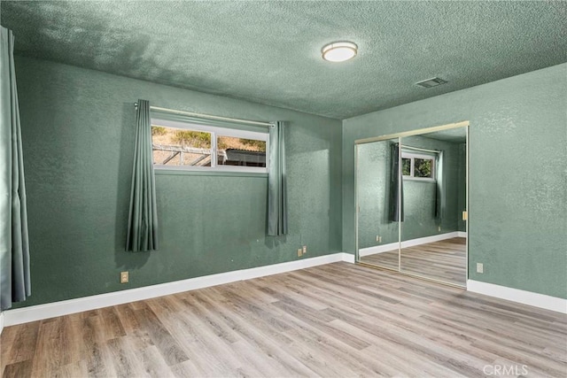 26865 Pine Canyon Rd, Lake Hughes, CA 93532 - spare room featuring wood finished floors, a textured wall, and a textured ceiling