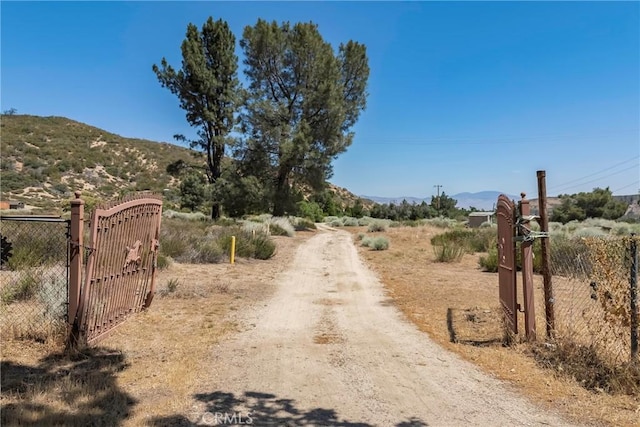 26865 Pine Canyon Rd, Lake Hughes, CA 93532 - view of road featuring a mountain view, a gate, and a gated entry