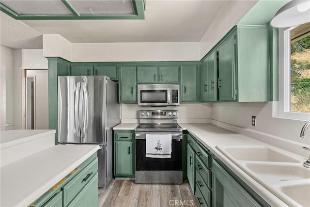 26865 Pine Canyon Rd, Lake Hughes, CA 93532 - kitchen featuring green cabinetry, stainless steel appliances, and light countertops