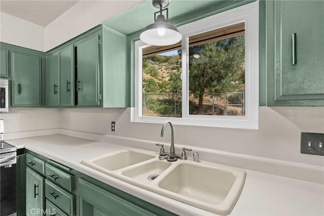 26865 Pine Canyon Rd, Lake Hughes, CA 93532 - kitchen featuring green cabinetry, stainless steel electric stove, light countertops, and hanging light fixtures