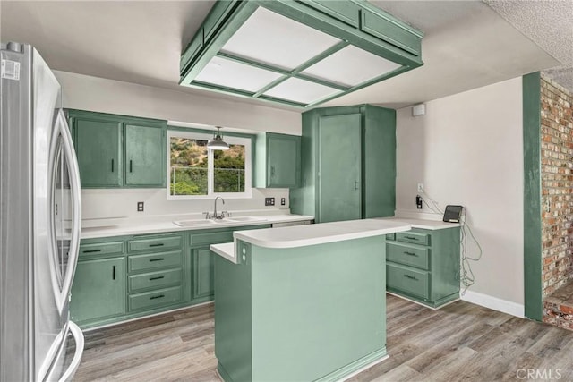 26865 Pine Canyon Rd, Lake Hughes, CA 93532 - kitchen featuring green cabinets, freestanding refrigerator, and light wood-style floors