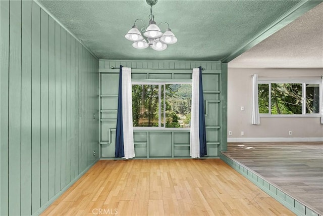 26865 Pine Canyon Rd, Lake Hughes, CA 93532 - entryway with wood finished floors, a textured ceiling, a chandelier, and wood walls