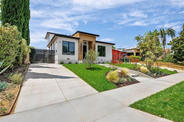 555 N Plymouth Blvd, Hancock Park, CA 90004 - contemporary home featuring driveway, a front yard, and a gate