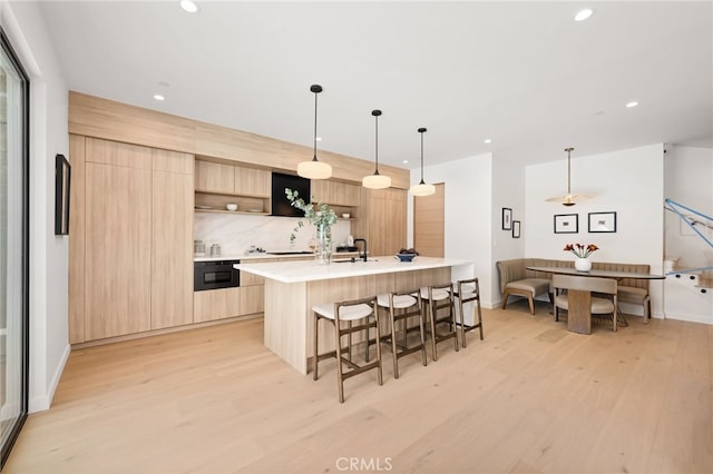 555 N Plymouth Blvd, Hancock Park, CA 90004 - kitchen featuring modern cabinets, light brown cabinetry, light wood-style flooring, recessed lighting, and light countertops