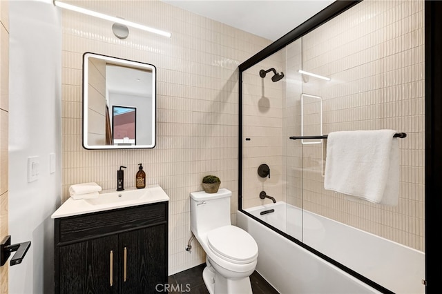 555 N Plymouth Blvd, Hancock Park, CA 90004 - bathroom with vanity, combined bath / shower with glass door, and tile walls