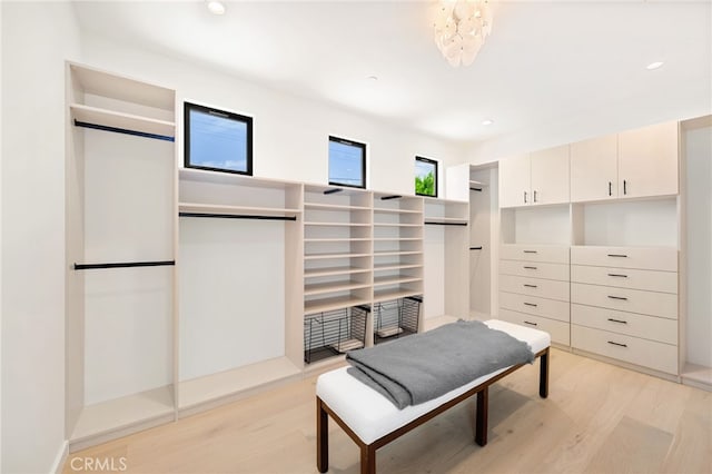 555 N Plymouth Blvd, Hancock Park, CA 90004 - walk in closet featuring light wood-style floors and a chandelier