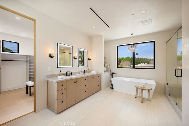 555 N Plymouth Blvd, Hancock Park, CA 90004 - full bath with a soaking tub, double vanity, a shower stall, a spacious closet, and recessed lighting
