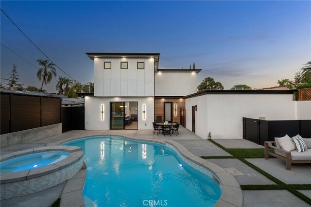 555 N Plymouth Blvd, Hancock Park, CA 90004 - rear view of property featuring a patio, a fenced backyard, stucco siding, a pool with connected hot tub, and outdoor dining area