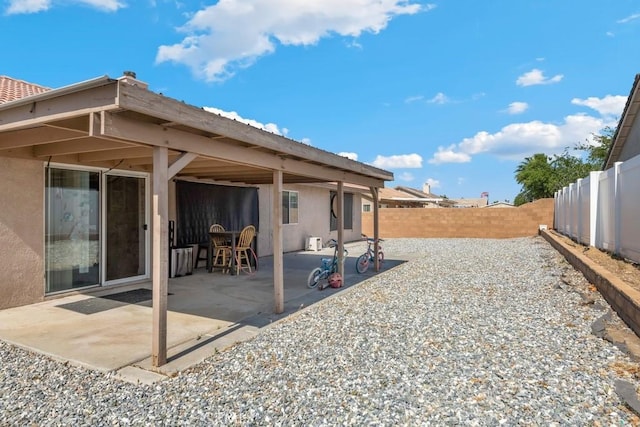 14389 Northstar Ave, Victorville, CA 92392 - rear view of property featuring a fenced backyard, stucco siding, and a patio area