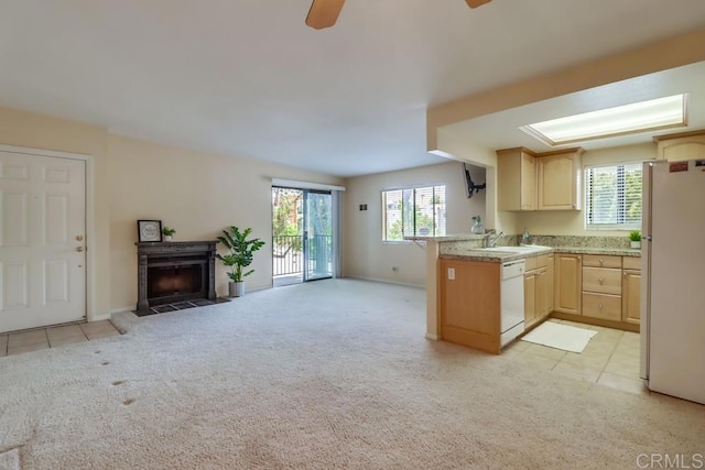 2917 C St Unit 186, San Diego, CA 92102 - kitchen with white appliances, a peninsula, open floor plan, light brown cabinets, and light carpet