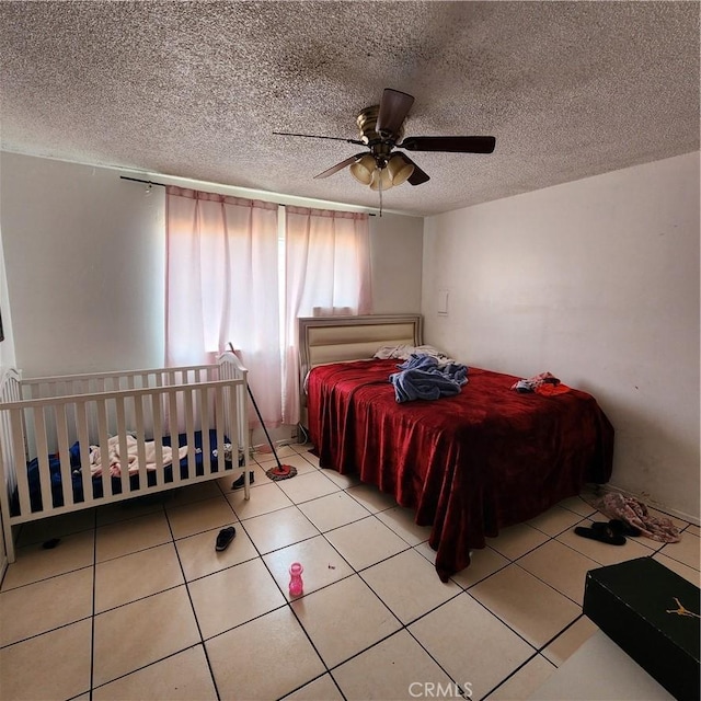 3322 E 8th St, Los Angeles, CA 90023 - tiled bedroom featuring a textured ceiling and ceiling fan