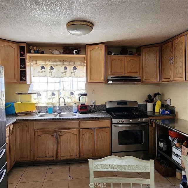 3322 E 8th St, Los Angeles, CA 90023 - kitchen featuring stainless steel range with gas cooktop, exhaust hood, brown cabinets, light tile patterned flooring, and a textured ceiling