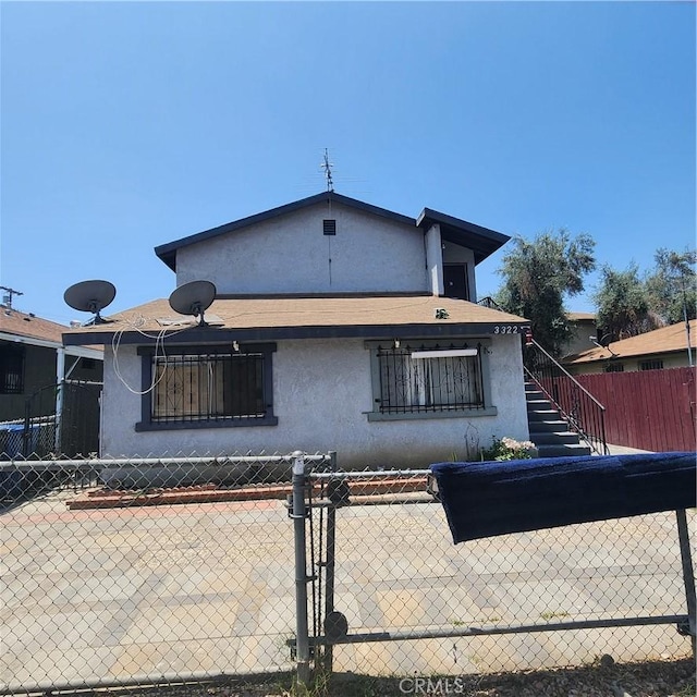 3322 E 8th St, Los Angeles, CA 90023 - back of property featuring stucco siding and stairs