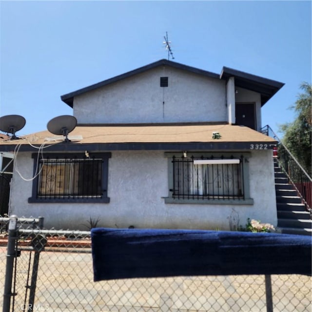 3322 E 8th St, Los Angeles, CA 90023 - back of property with stucco siding and stairway