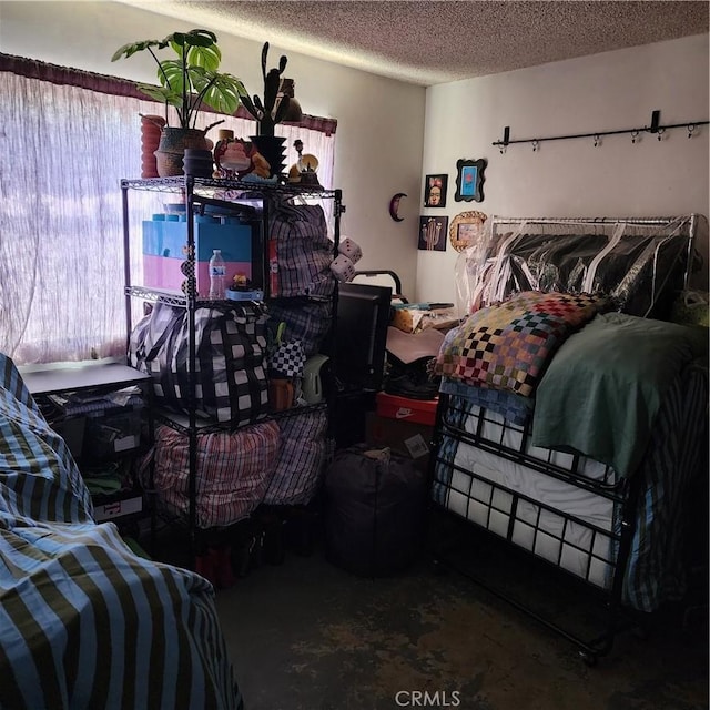 3322 E 8th St, Los Angeles, CA 90023 - bedroom featuring multiple windows, a textured ceiling, and concrete floors