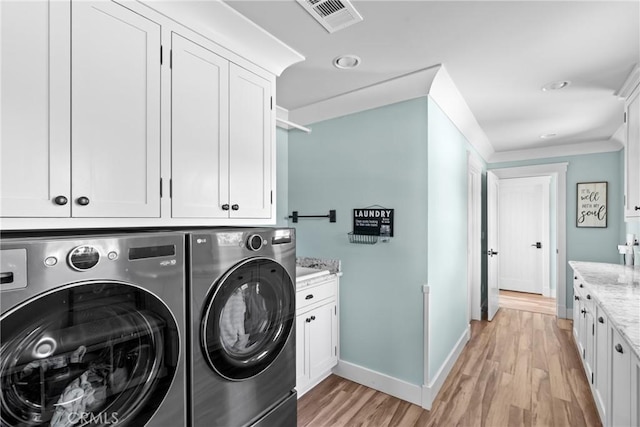 10270 Santa Ana Rd, Atascadero, CA 93422 - laundry area featuring separate washer and dryer, cabinet space, and light wood-style floors