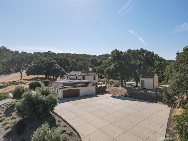 10270 Santa Ana Rd, Atascadero, CA 93422 - view of patio / terrace with a garage, concrete driveway, a shed, and a forest view