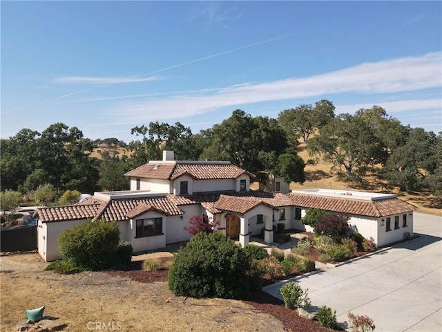 10270 Santa Ana Rd, Atascadero, CA 93422 - view of front of home featuring stucco siding, a chimney, a tiled roof, and roof mounted solar panels