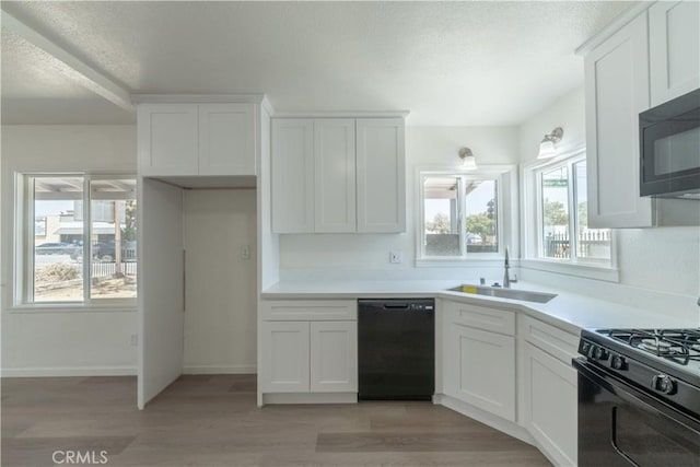 10010 Cedar Ave, Bloomington, CA 92316 - kitchen with black appliances, white cabinets, light wood-style floors, and a textured ceiling