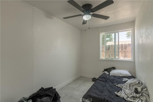 10010 Cedar Ave, Bloomington, CA 92316 - unfurnished bedroom with a textured wall, light tile patterned floors, and ceiling fan