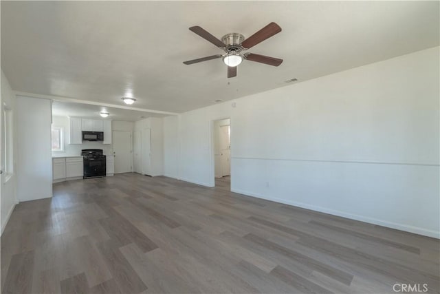 10010 Cedar Ave, Bloomington, CA 92316 - unfurnished living room with wood finished floors and a ceiling fan