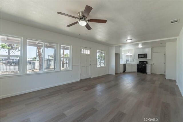 10010 Cedar Ave, Bloomington, CA 92316 - unfurnished living room featuring a ceiling fan and wood finished floors
