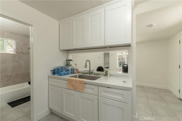 10010 Cedar Ave, Bloomington, CA 92316 - kitchen featuring light countertops, white cabinets, and light tile patterned flooring