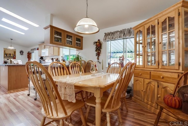 1750 W Citracado Pkwy Unit 157, Escondido, CA 92029 - dining area featuring washer and clothes dryer, light wood finished floors, and vaulted ceiling