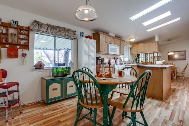 1750 W Citracado Pkwy Unit 157, Escondido, CA 92029 - dining room featuring light wood-style flooring and vaulted ceiling
