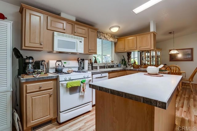 1750 W Citracado Pkwy Unit 157, Escondido, CA 92029 - kitchen with white appliances, light wood-type flooring, light brown cabinetry, a kitchen island, and vaulted ceiling
