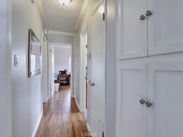 7840 La Mesa Way, Buena Park, CA 90620 - hallway featuring a textured ceiling, light wood-type flooring, and crown molding