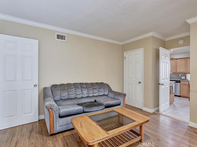 7840 La Mesa Way, Buena Park, CA 90620 - living room featuring light wood-type flooring, crown molding, and a textured ceiling