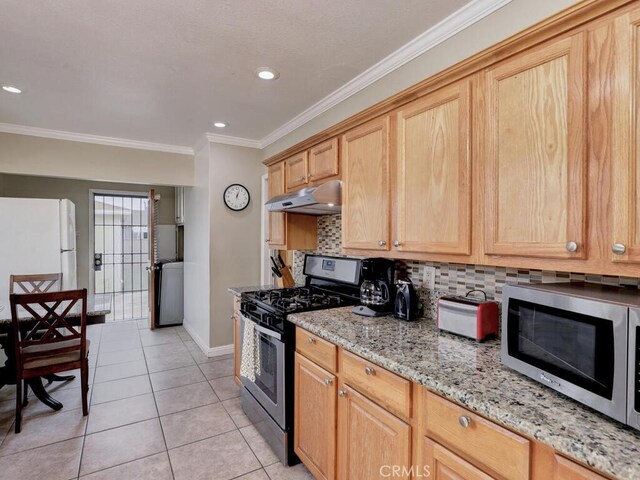 7840 La Mesa Way, Buena Park, CA 90620 - kitchen featuring stainless steel appliances, under cabinet range hood, tasteful backsplash, light tile patterned flooring, and ornamental molding