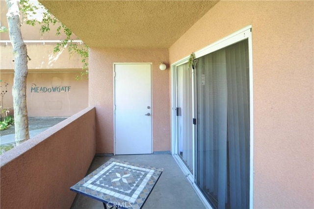 12601 Van Nuys Blvd Unit 103, Pacoima, CA 91331 - view of exterior entry with a balcony and stucco siding