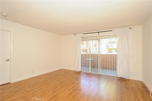 12601 Van Nuys Blvd Unit 103, Pacoima, CA 91331 - spare room featuring light wood finished floors, a smoke detector, and a textured ceiling