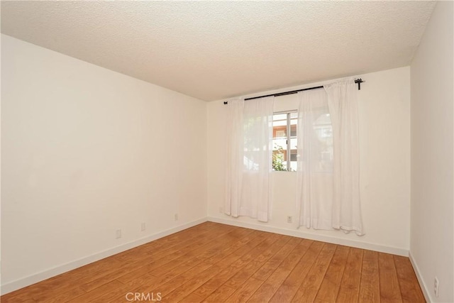 12601 Van Nuys Blvd Unit 103, Pacoima, CA 91331 - empty room with light wood-type flooring and a textured ceiling