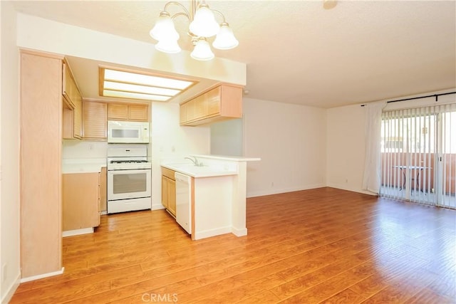 12601 Van Nuys Blvd Unit 103, Pacoima, CA 91331 - kitchen with white appliances, a chandelier, light countertops, light wood-type flooring, and light brown cabinetry