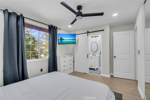 10480 Bryan St, Riverside, CA 92505 - bedroom with a barn door, wood finished floors, recessed lighting, and a ceiling fan
