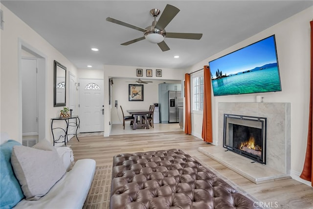 10480 Bryan St, Riverside, CA 92505 - living area featuring a ceiling fan, light wood-type flooring, a high end fireplace, and recessed lighting