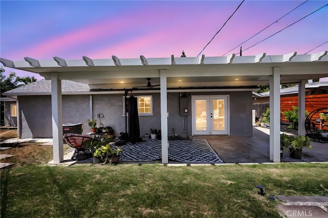 10480 Bryan St, Riverside, CA 92505 - back of property at dusk with a patio area, stucco siding, and french doors