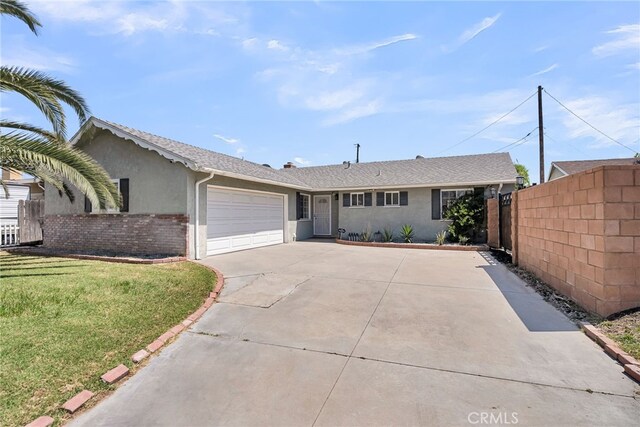 10480 Bryan St, Riverside, CA 92505 - ranch-style house with concrete driveway, a garage, and stucco siding