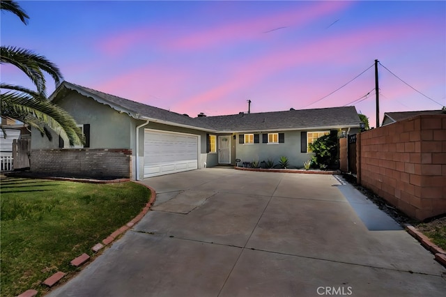 10480 Bryan St, Riverside, CA 92505 - ranch-style house with driveway, stucco siding, an attached garage, and brick siding