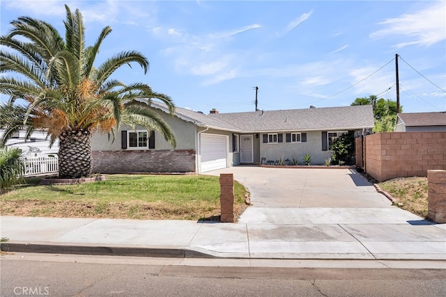 10480 Bryan St, Riverside, CA 92505 - view of front of property featuring driveway, an attached garage, and stucco siding