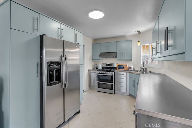 10480 Bryan St, Riverside, CA 92505 - kitchen with appliances with stainless steel finishes, under cabinet range hood, pendant lighting, and light tile patterned floors