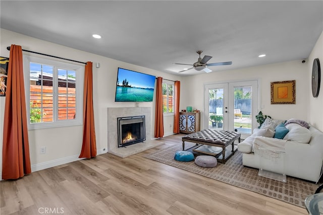 10480 Bryan St, Riverside, CA 92505 - living area with french doors, plenty of natural light, wood finished floors, a tiled fireplace, and recessed lighting