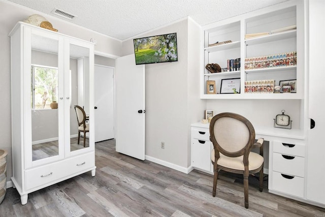 834 Cole Ranch Rd, Encinitas, CA 92024 - home office featuring wood finished floors, french doors, a textured ceiling, and built in desk