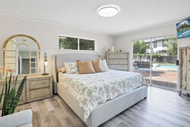 834 Cole Ranch Rd, Encinitas, CA 92024 - bedroom featuring access to outside, a textured ceiling, and wood finished floors