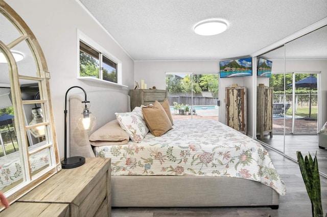 834 Cole Ranch Rd, Encinitas, CA 92024 - bedroom featuring access to exterior, a textured ceiling, and wood finished floors