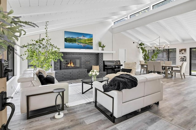 834 Cole Ranch Rd, Encinitas, CA 92024 - living area featuring a brick fireplace, a chandelier, and wood finished floors